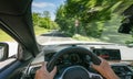 Hands of car driver on steering wheel, road trip, driving on highway road