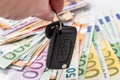 Hands with car keys on euro money background Royalty Free Stock Photo