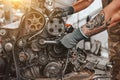 Hands of car mechanic repairs the car engine in auto repair service Royalty Free Stock Photo