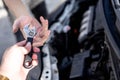 Hands of car mechanic with wrench in garage. The hand of a car mechanic with a wrench in the workshop Royalty Free Stock Photo