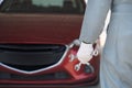 Hands of car mechanic with wrench in garage