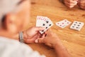 Hands, cards and a senior man playing poker at a table in the living room of a retirement home. Gambling, planning and Royalty Free Stock Photo