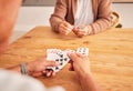 Hands, cards and a senior man playing a game at a table in the living room of a retirement home. Thinking, planning and Royalty Free Stock Photo