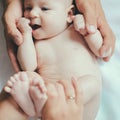 The hands that care. Newborn baby in parents hands. Newborn baby given body massage. Body skin care. Keep babys skin