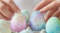 Hands carefully embellish vibrant Easter eggs adorned with intricate floral patterns Royalty Free Stock Photo