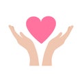 Hands carefully hold the heart. The concept of mercy, charity, kindness and love