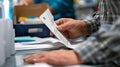 Absentee Ballot Envelope Sealing Process for Secure Voting and Election Preparation Royalty Free Stock Photo