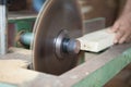 hands of the carpenter or craftsman cut a piece of wood to Machine Electronic Table Circular saw blade