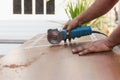 Hands of carpenter cutting piece of wood with electric circular saw. Royalty Free Stock Photo