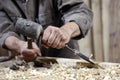 Hands of carpenter with a hammer and chisel on workbench in carpentry Royalty Free Stock Photo