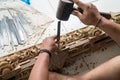 Hands of a carpenter making traditional wood carving in Bali