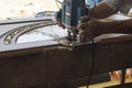 Hands of Carpenter Planing the Wood Plank by Electric Planer Machine. Royalty Free Stock Photo