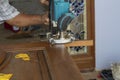 Hands of Carpenter Planing the Wood Plank by Electric Planer Machine. Royalty Free Stock Photo