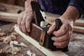 Hands of a carpenter using a vintage plane Royalty Free Stock Photo