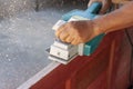 The hands of a carpenter were using an electric planer. Royalty Free Stock Photo