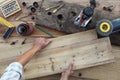 Hands carpenter work the wood, combine old rustic wooden boards