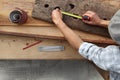 Hands carpenter work the wood, measure with the meter a old rust Royalty Free Stock Photo