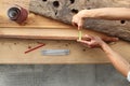 hands carpenter work the wood, measure with the meter the thickness of a old rustic wooden boards, top view and copy space Royalty Free Stock Photo