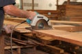 Hands of carpenter is working with a circular saw in carpentry workshop. Royalty Free Stock Photo