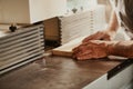 Hands of a carpenter working with a panel of wood on a workbench Royalty Free Stock Photo