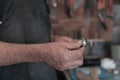 Hands carving spoon from wood, working with chisel close up. Wooden workshop. Process of making wooden spoon Royalty Free Stock Photo