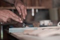 Hands carving spoon from wood, working with chisel close up. Wooden workshop. Process of making wooden spoon Royalty Free Stock Photo