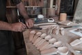 Hands carving spoon from wood, working with chisel close up. Wooden workshop. Process of making wooden spoon Royalty Free Stock Photo