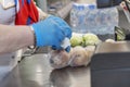 Hands of the cashier in medical gloves scanning the goods. Close-up. Precautions during the coronavirus pandemic