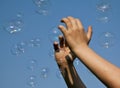 Hands catching bubbles Royalty Free Stock Photo