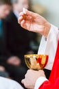 Hands of a catholic priest with chalice and host at Communion Royalty Free Stock Photo