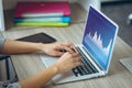 Hands of caucasian businesswoman using laptop, with graphs on laptop screen Royalty Free Stock Photo