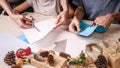 Hands of a caucasian girl and her brother are cutting paper snowflakes with scissors. Handmade, christmas decorations, family Royalty Free Stock Photo