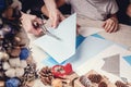 Hands of a caucasian mother and her daughter are cutting paper snowflakes with scissors. Handmade, christmas decorations, family Royalty Free Stock Photo