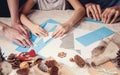 Hands of a caucasian mother and her daughter are cutting paper snowflakes with scissors. Handmade, christmas decorations, family Royalty Free Stock Photo