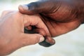 Hands of a Caucasian woman and an African man Royalty Free Stock Photo