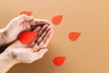 Hands of caucasian woman cupping blood drop, with blood drops on brown background, copy space