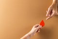 Hands of caucasian woman passing blood drop to caucasian man, on brown background with copy space Royalty Free Stock Photo