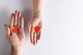 Hands of caucasian woman and man holding blood drops, on white background with copy space Royalty Free Stock Photo