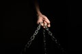 Hands are chained in chains isolated on black background Royalty Free Stock Photo