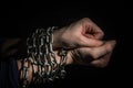 Hands chained in chains isolated on black background Royalty Free Stock Photo