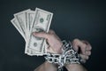 Hands chained together holds money Royalty Free Stock Photo