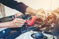 Hands check battery car mechanic working in auto repair service Royalty Free Stock Photo