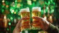 Hands cheer with Irish beer in green shamrocks background for St. Patrick& x27;s day festive