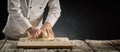 Hands of a chef or baker kneading raw dough