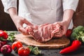 Hands Chef Butcher holdind pork meat on kitchen, cooking food Royalty Free Stock Photo