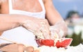 Hands of chef cook working with dough and flour. Bakery concept. Bowl with dough, rolling pin and flour scattered all Royalty Free Stock Photo