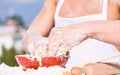 Hands of chef cook working with dough and flour. Bakery concept. Bowl with dough, rolling pin and flour scattered all Royalty Free Stock Photo