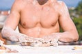 Hands of chef cook working with dough and flour, muscular torso on background. Bakery concept. Hands of muscular baker Royalty Free Stock Photo