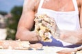 Hands of chef cook working with sticky dough and flour. Bakery concept. Dough, rolling pin and flour scattered all Royalty Free Stock Photo