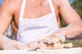 Hands of chef cook working with sticky dough and flour. Bakery concept. Hands of muscular baker or cook kneading raw Royalty Free Stock Photo